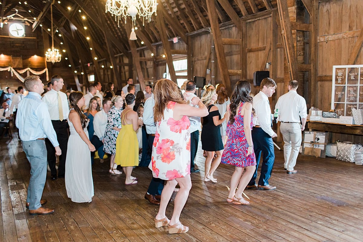 Arielle Peters Photography | Wedding guests dancing inside historic barn on wedding day at St. Joe Farm in Granger, Indiana.