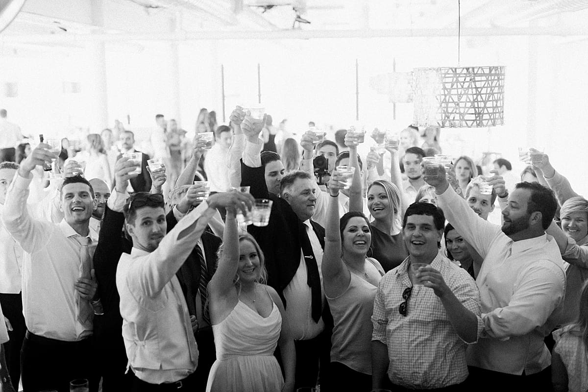 Arielle Peters Photography | Wedding guests raising a glass at wedding reception on wedding day at Loft 310 in Kalamazoo, Michigan.