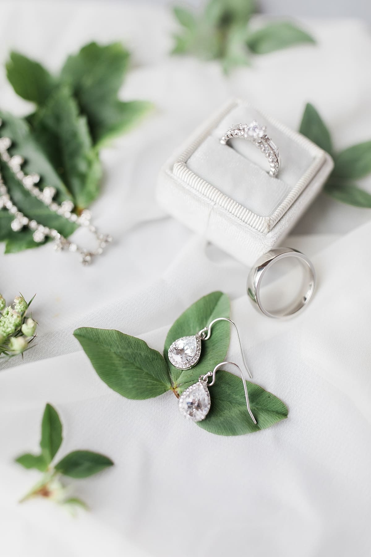 Arielle Peters Photography | Wedding rings lying on greenery on wedding day in Fort Wayne, Indiana. 
