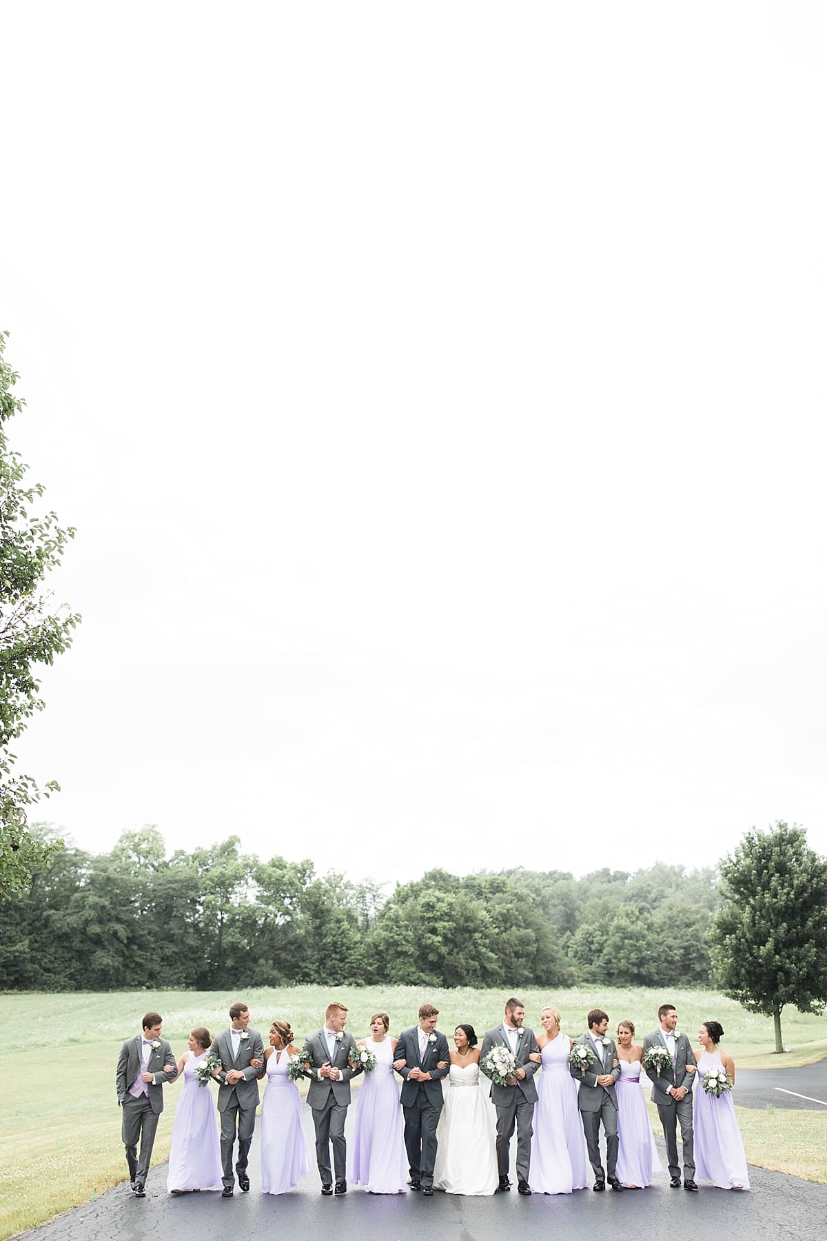 Arielle Peters Photography | Wedding party walking on street on wedding day in Fort Wayne, Indiana. 