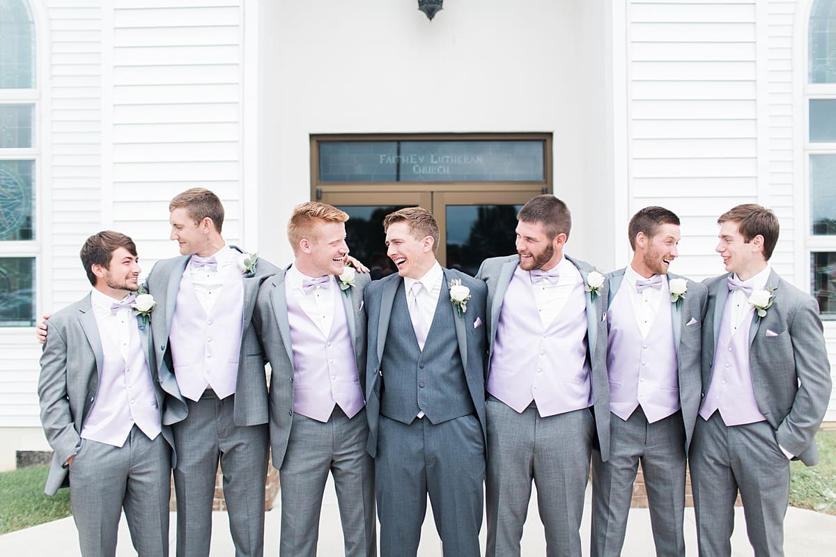 Arielle Peters Photography | Groom and groomsmen laughing outside church on wedding day in Fort Wayne, Indiana. 