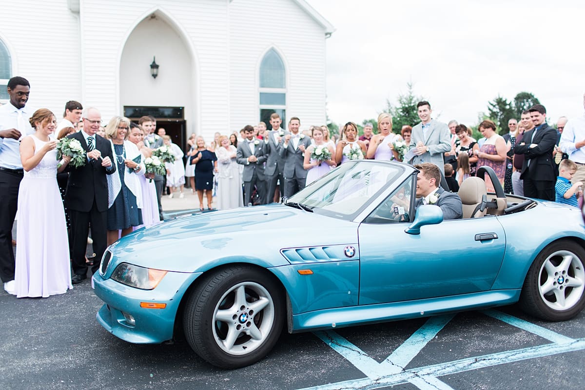 Arielle Peters Photography | Bride and groom driving away on wedding day in Fort Wayne, Indiana. 