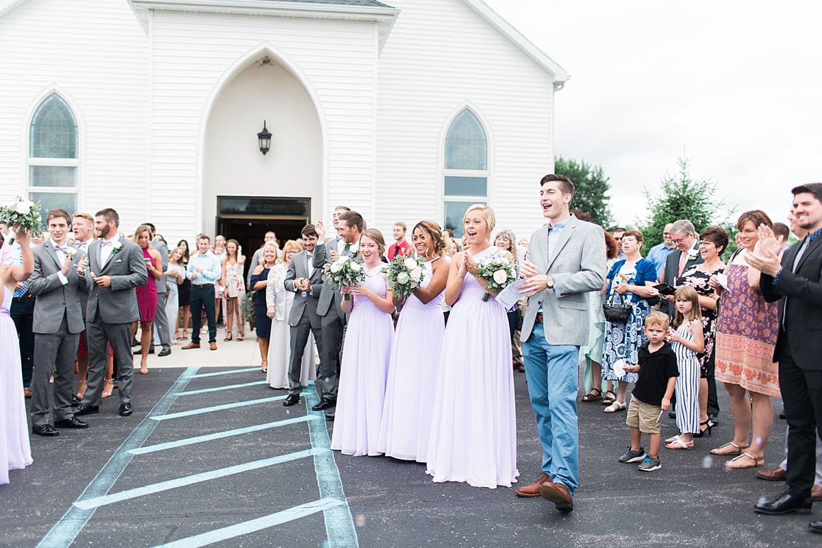 Arielle Peters Photography | Wedding guests cheering outside church on wedding day in Fort Wayne, Indiana. 