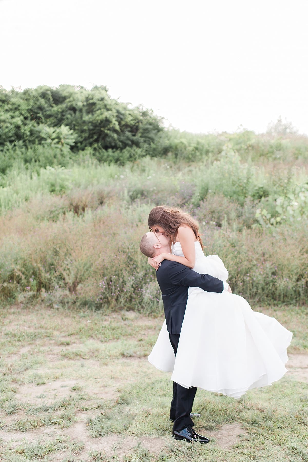 Arielle Peters Photography | Bride and groom kissing outside on wedding day at The Inn at Harbor Springs in St. Joseph, Michigan.