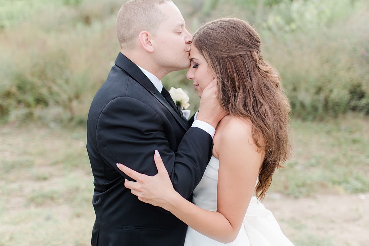 Arielle Peters Photography | Bride and groom kissing outside on wedding day at The Inn at Harbor Springs in St. Joseph, Michigan.