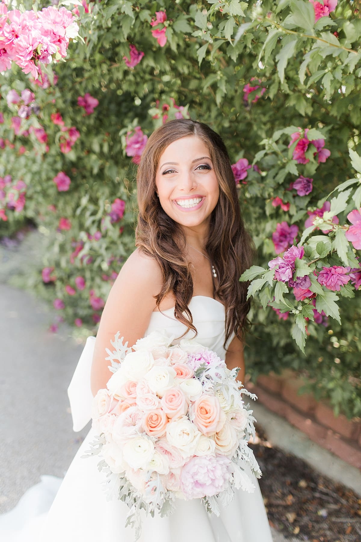 Arielle Peters Photography | Bride under blossom tree outside on summer wedding day at The Inn at Harbor Springs in St. Joseph, Michigan.