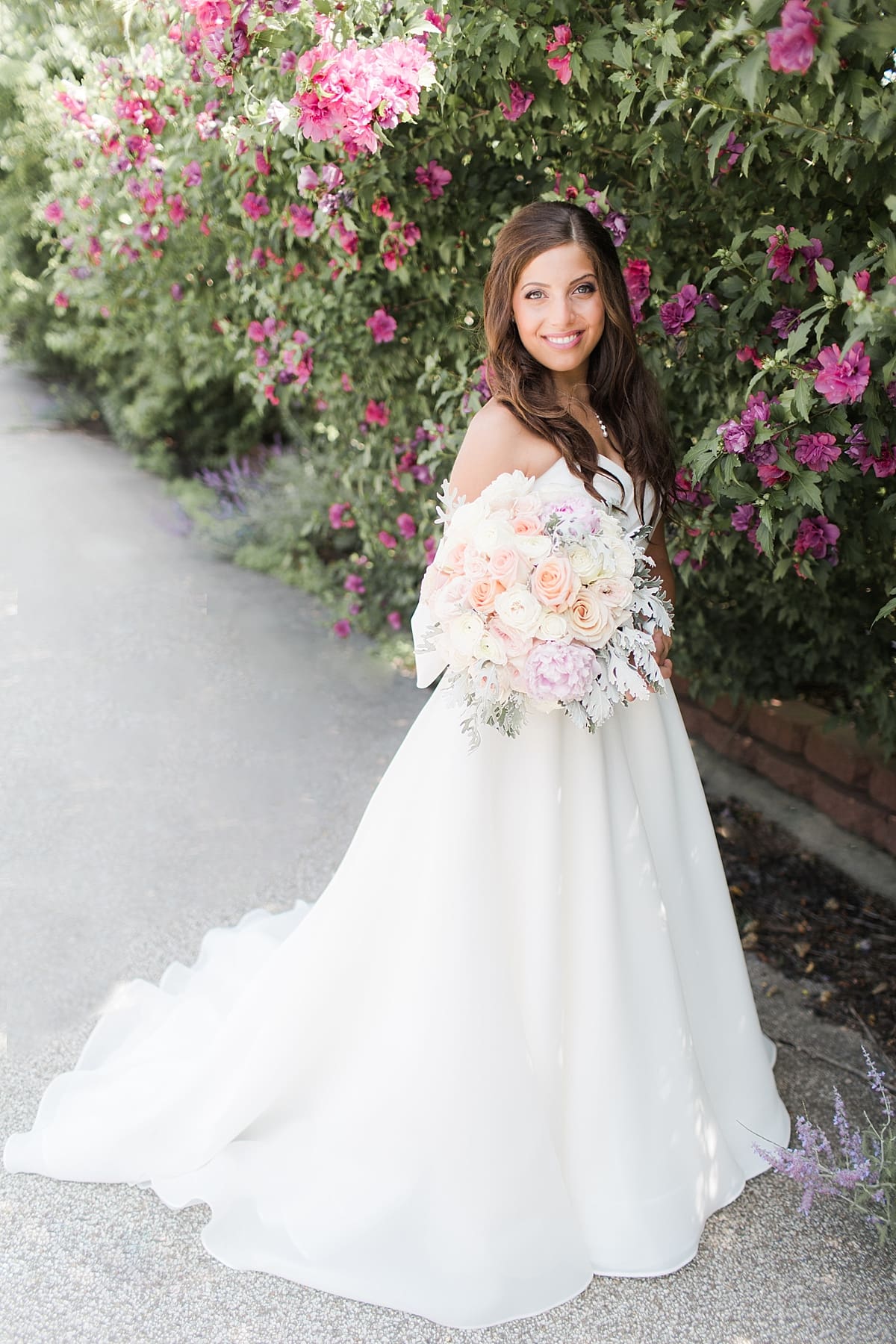 Arielle Peters Photography | Bride under blossom tree outside on summer wedding day at The Inn at Harbor Springs in St. Joseph, Michigan.