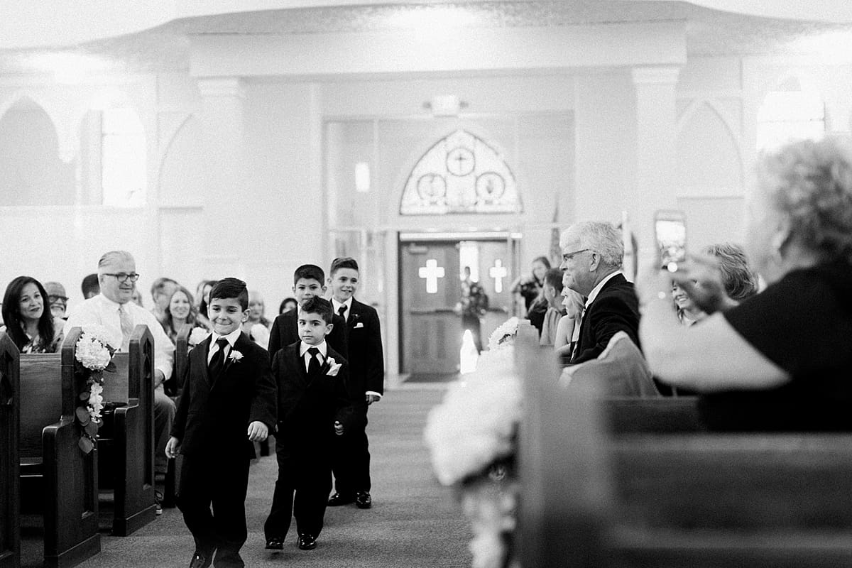 Arielle Peters Photography | Ring bearers walking down aisle on summer wedding day at The Inn at Harbor Springs in St. Joseph, Michigan.