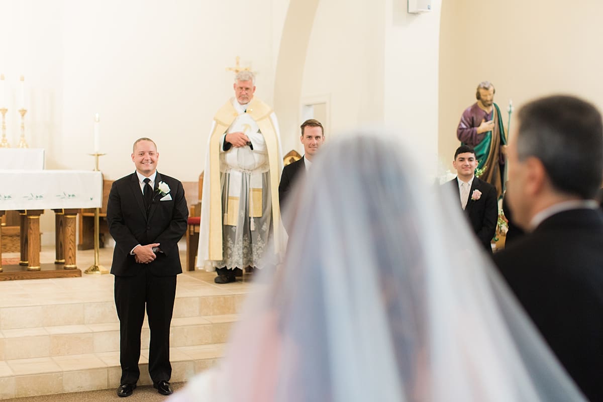 Arielle Peters Photography | Groom smiling at the bride in the aisle on summer wedding day at The Inn at Harbor Springs in St. Joseph, Michigan.