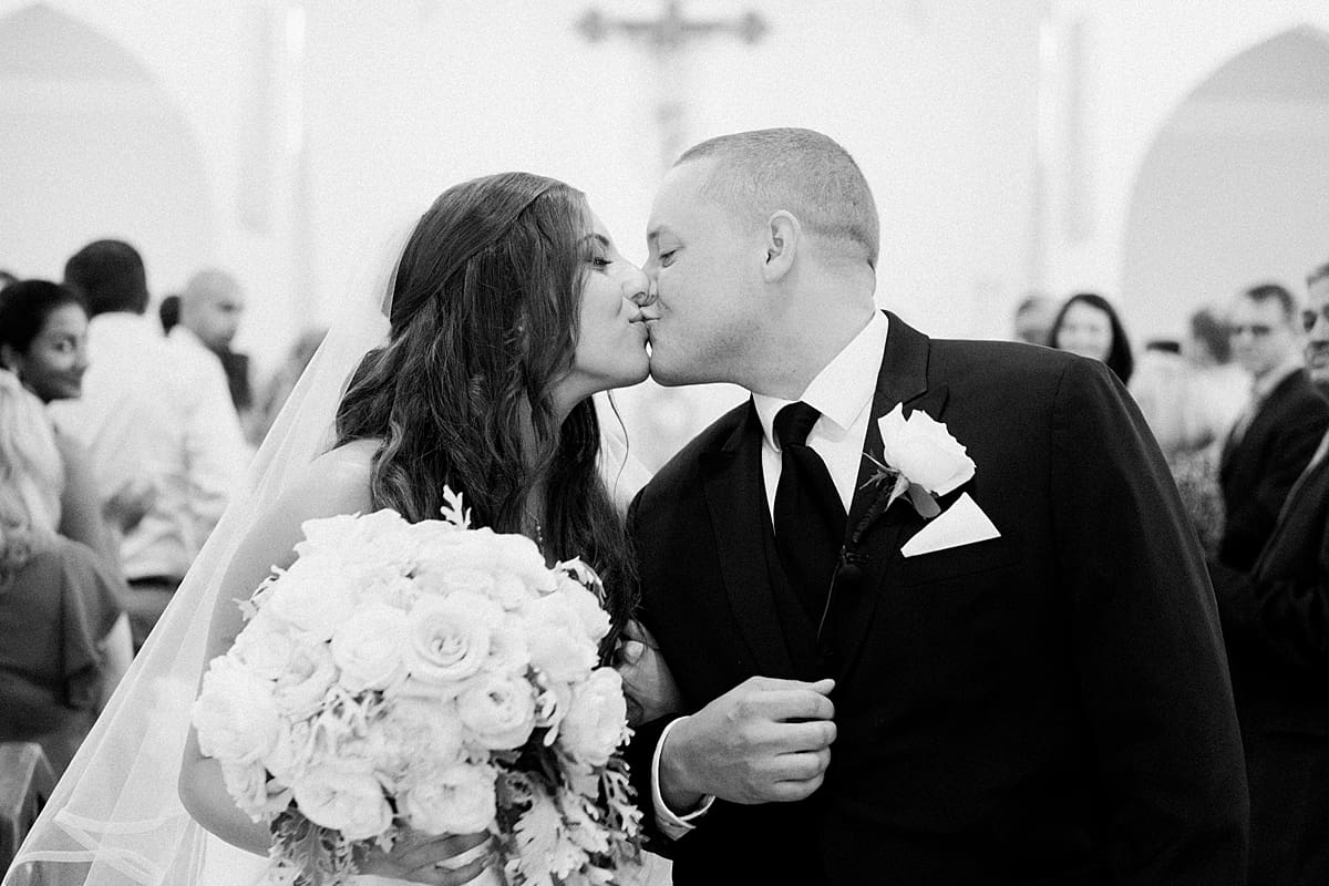 Arielle Peters Photography | Bride and groom kissing in the aisle on summer wedding day at The Inn at Harbor Springs in St. Joseph, Michigan.