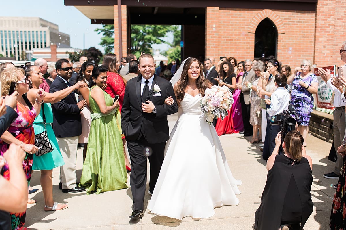 Arielle Peters Photography | Bride and groom leaving the church on summer wedding day at The Inn at Harbor Springs in St. Joseph, Michigan.