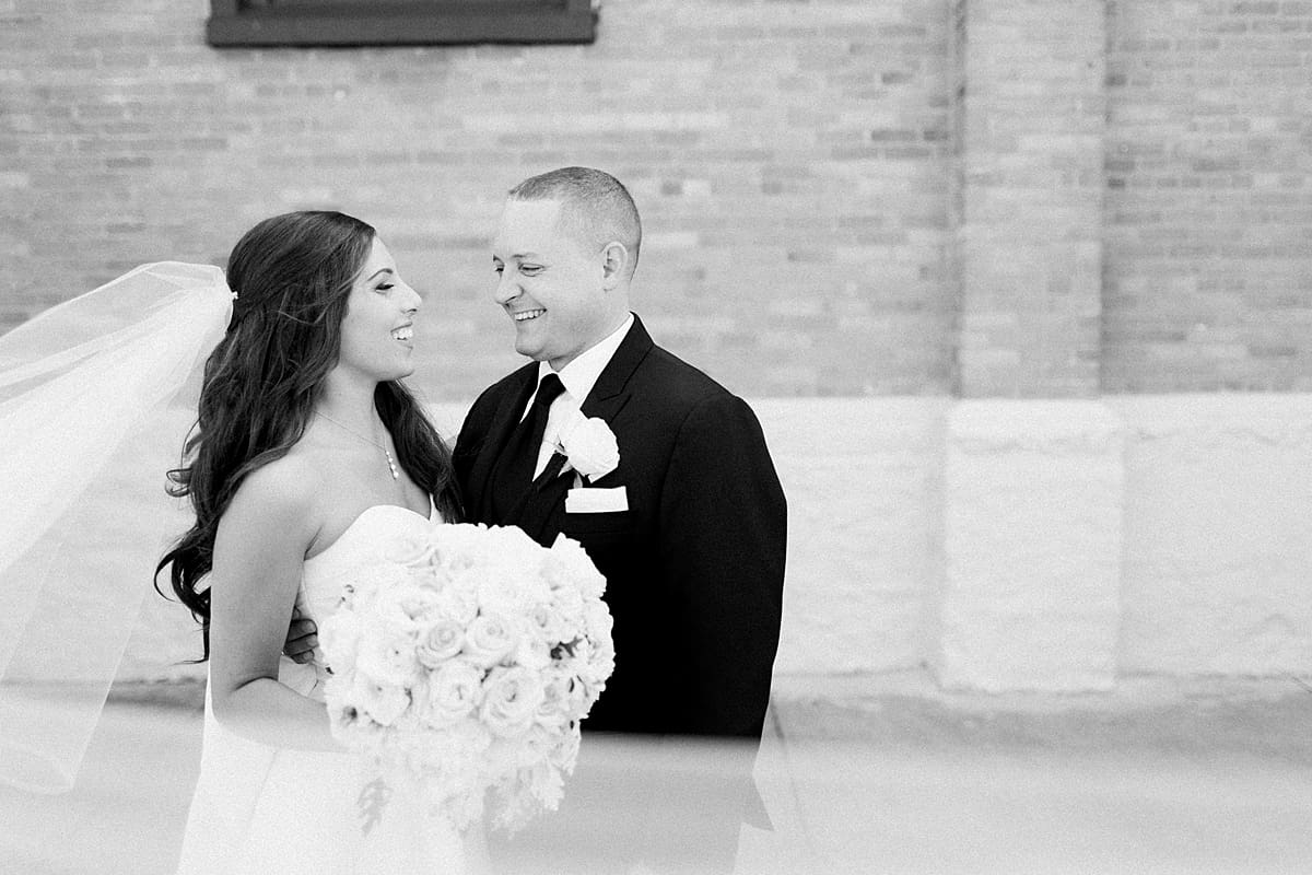 Arielle Peters Photography | Bride and groom smiling outside of church on summer wedding day at The Inn at Harbor Springs in St. Joseph, Michigan.