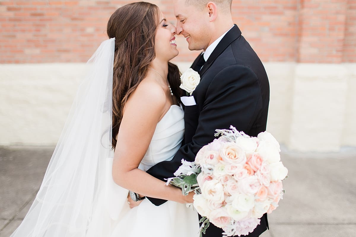 Arielle Peters Photography | Bride and groom smiling outside of church on summer wedding day at The Inn at Harbor Springs in St. Joseph, Michigan.