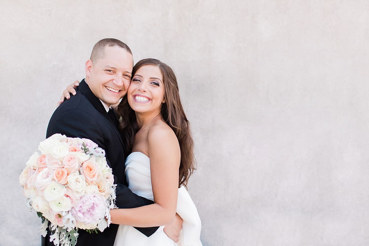 Arielle Peters Photography | Bride and groom smiling outside on summer wedding day at The Inn at Harbor Springs in St. Joseph, Michigan.