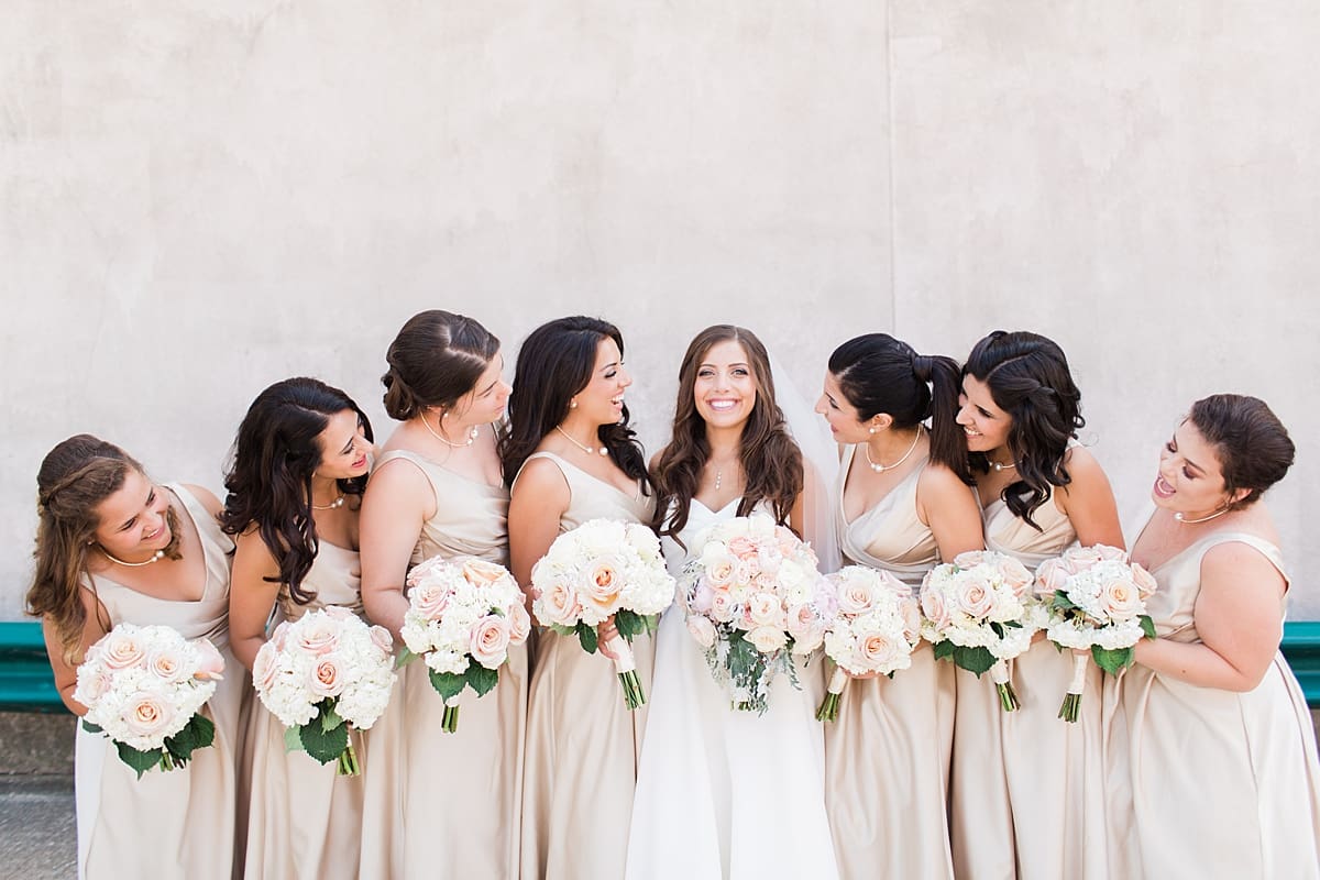 Arielle Peters Photography | Bride and bridesmaids smiling outside on summer wedding day at The Inn at Harbor Springs in St. Joseph, Michigan.