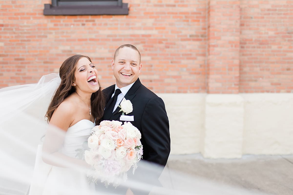 Arielle Peters Photography | Bride and groom laughing outside on summer wedding day at The Inn at Harbor Springs in St. Joseph, Michigan.