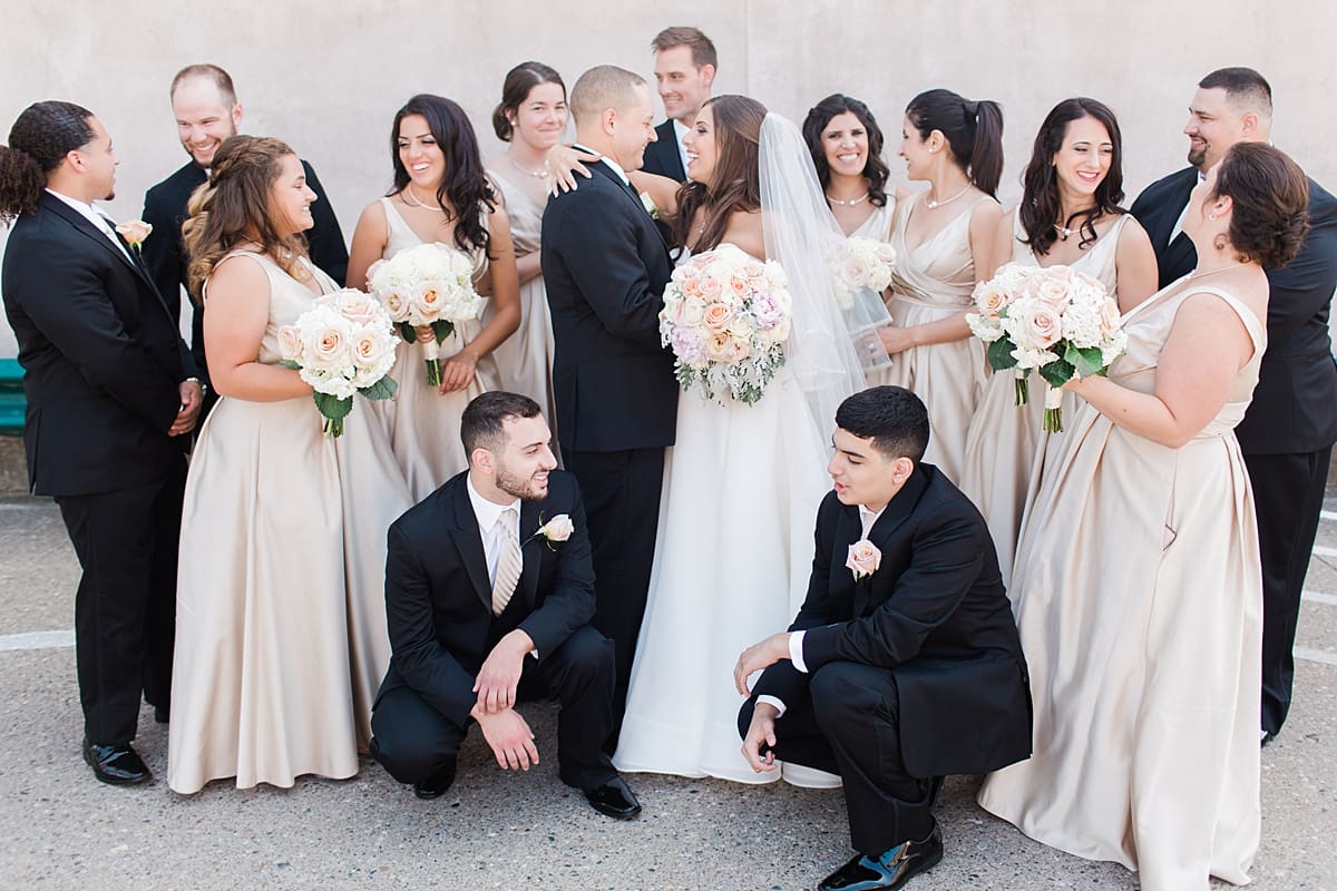 Arielle Peters Photography | Wedding party smiling outside on summer wedding day at The Inn at Harbor Springs in St. Joseph, Michigan.