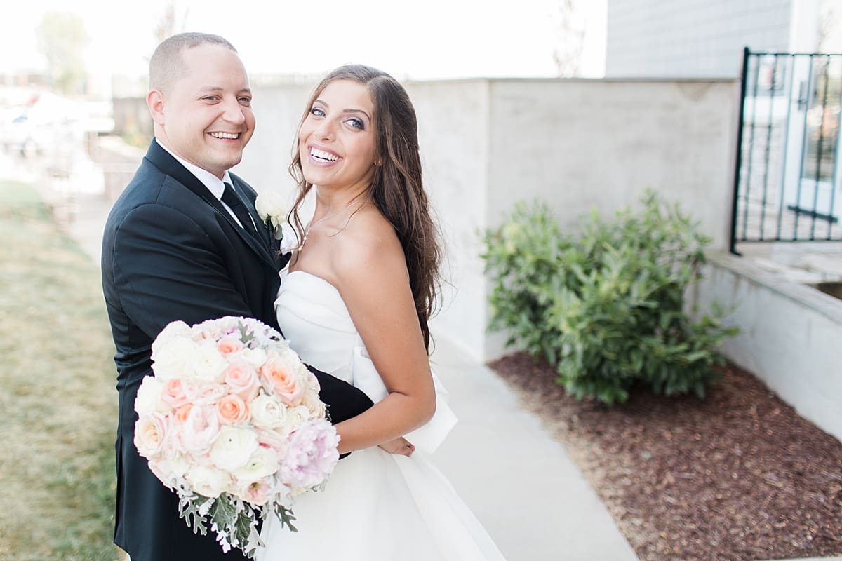 Arielle Peters Photography | Bride and groom smiling on summer wedding day at The Inn at Harbor Springs in St. Joseph, Michigan.
