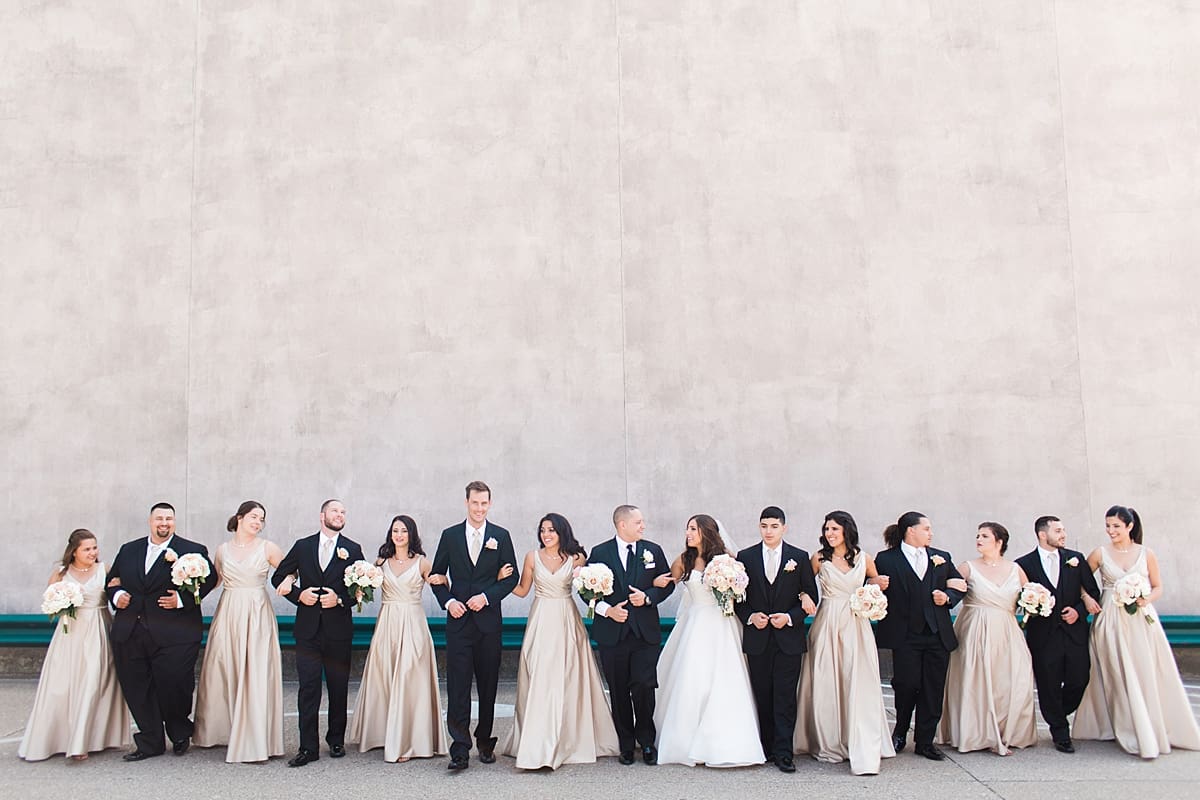 Arielle Peters Photography | Wedding party linking arms on summer wedding day at The Inn at Harbor Springs in St. Joseph, Michigan.