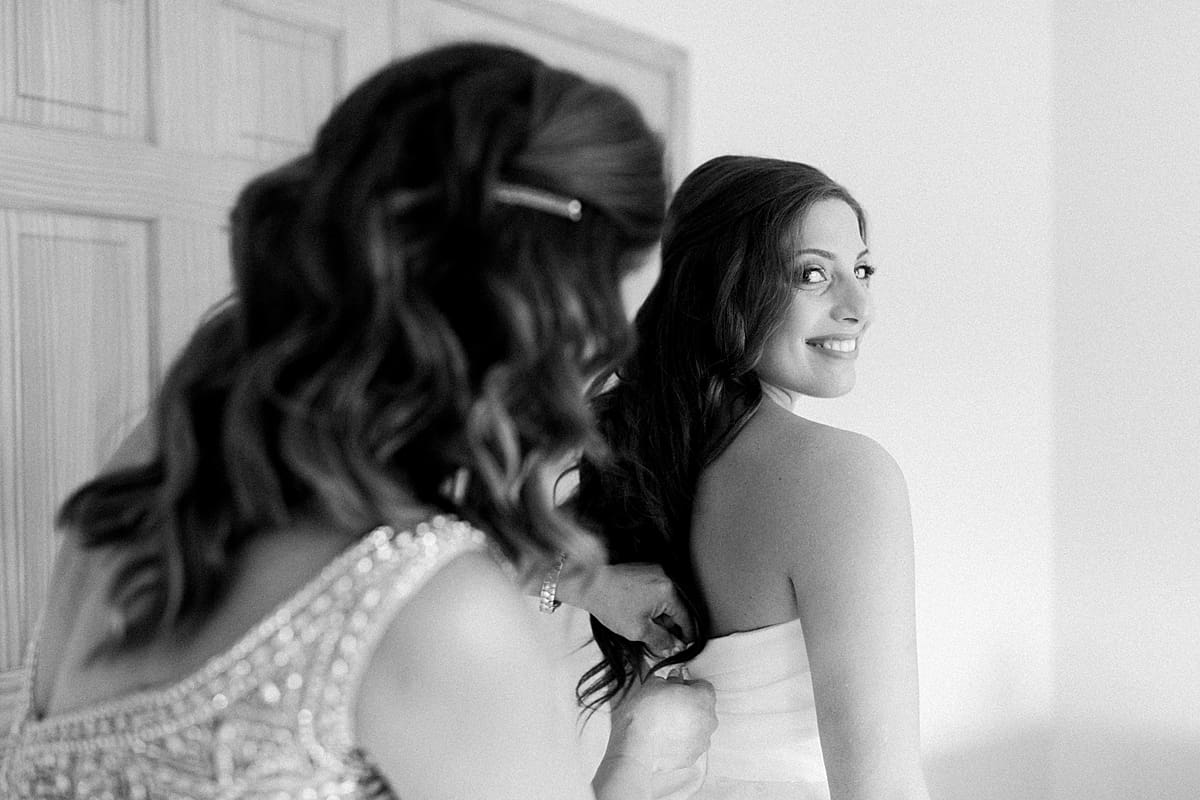 Arielle Peters Photography | Mother of the bride helping the bride get ready on wedding day at The Inn at Harbor Springs in St. Joseph, Michigan.