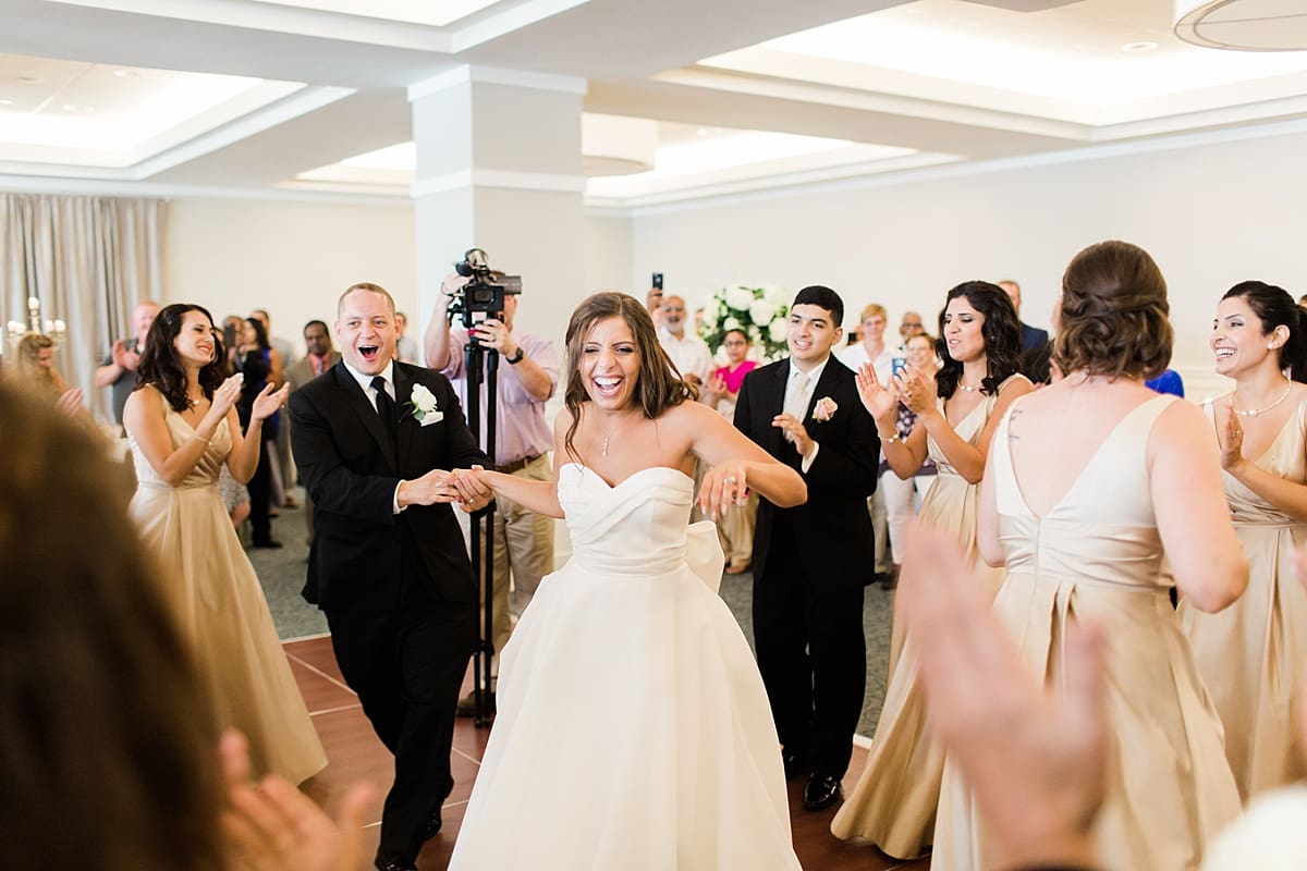 Arielle Peters Photography | Bride and groom entering wedding reception at The Inn at Harbor Springs in St. Joseph, Michigan.
