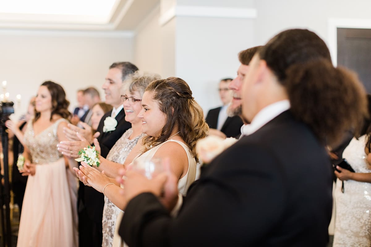 Arielle Peters Photography | Wedding guests cheering at wedding reception at The Inn at Harbor Springs in St. Joseph, Michigan.