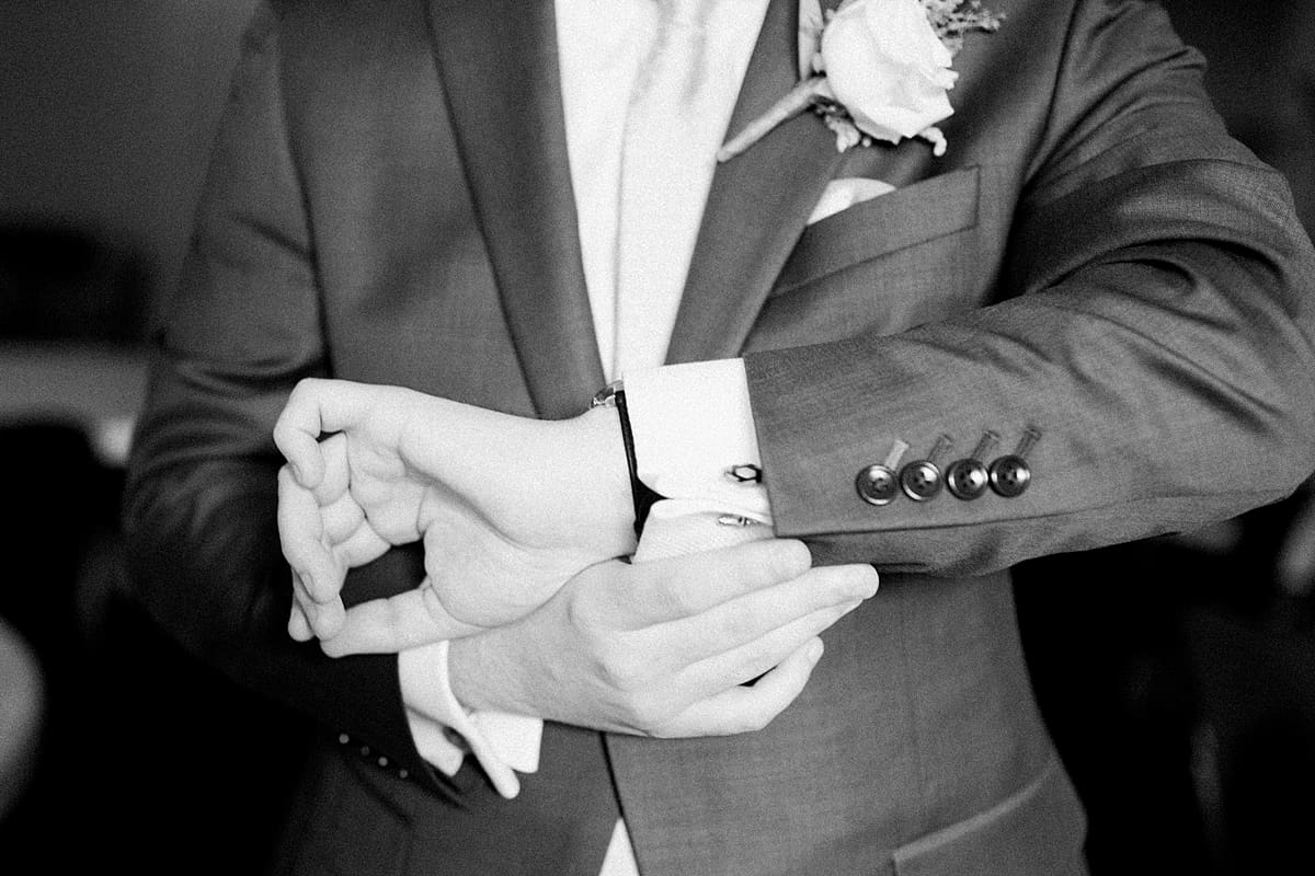 Arielle Peters Photography | Groom fastening tux cuffs on wedding day at Newlife Community Church in Chicago, Illinois.
