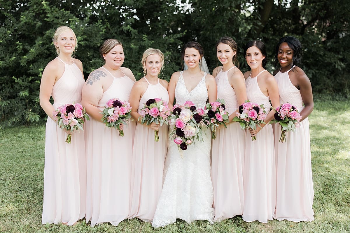 Arielle Peters Photography | Bride and bridesmaids holding bouquets outside on wedding day at Newlife Community Church in Chicago, Illinois.