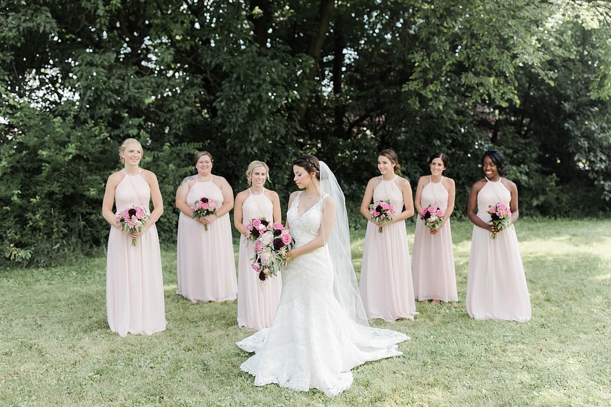 Arielle Peters Photography | Bride and bridesmaids holding bouquets outside on wedding day at Newlife Community Church in Chicago, Illinois.