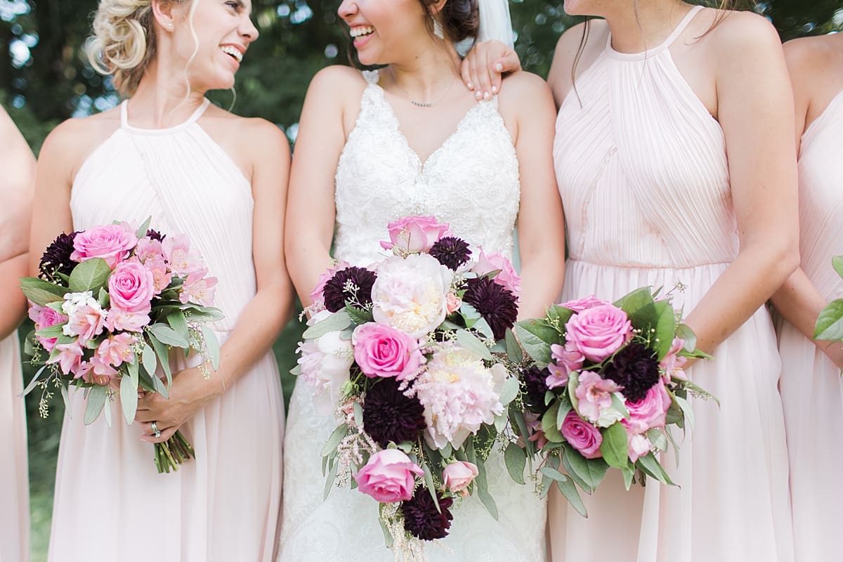 Arielle Peters Photography | Bride and bridesmaids holding bouquets outside on wedding day at Newlife Community Church in Chicago, Illinois.