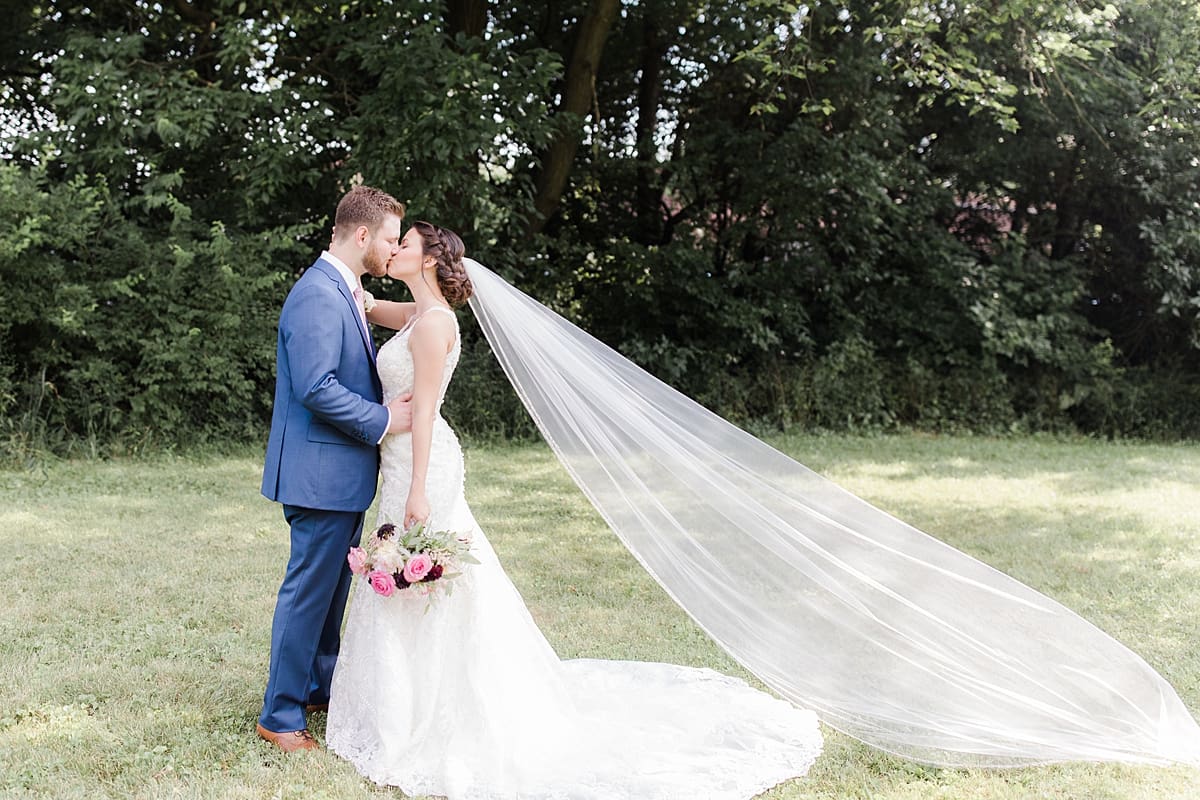 Arielle Peters Photography | Bride and groom kissing in open field on wedding day at Newlife Community Church in Chicago, Illinois.