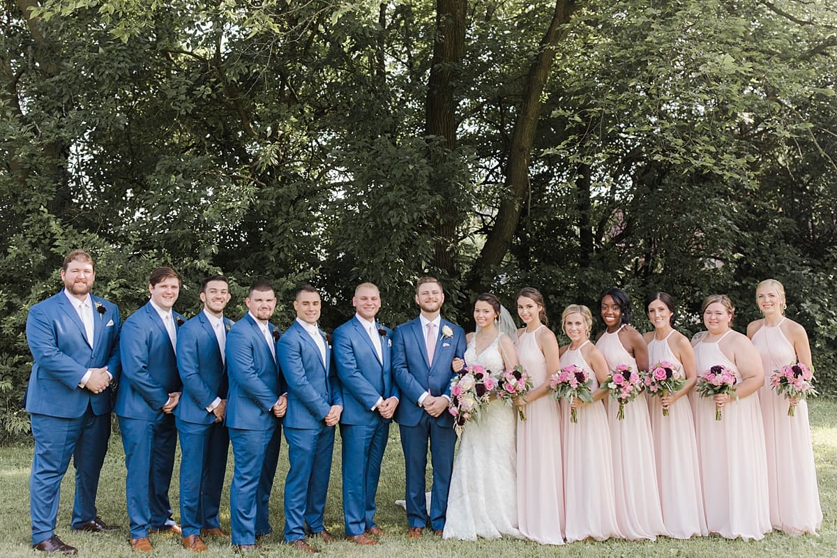 Arielle Peters Photography | Wedding party standing in open field on wedding day at Newlife Community Church in Chicago, Illinois.