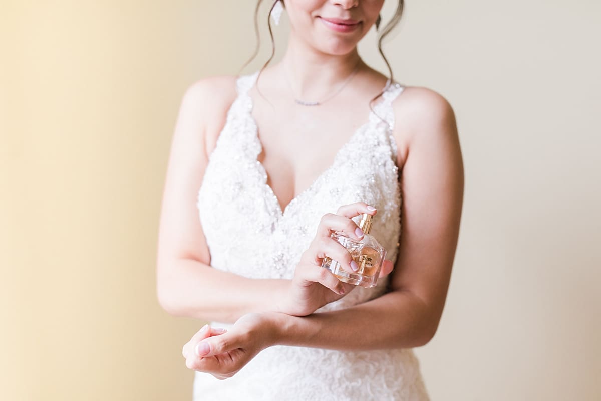 Arielle Peters Photography | Bride putting on wedding day perfume on wedding day at Newlife Community Church in Chicago, Illinois.