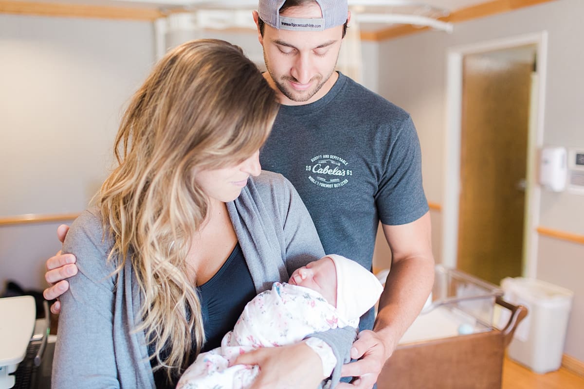 Arielle Peters Photography | Husband and wife caring for their newborn baby.