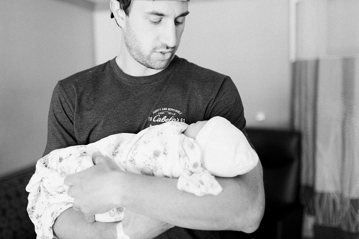 Arielle Peters Photography | New dad holding his newborn baby girl. 