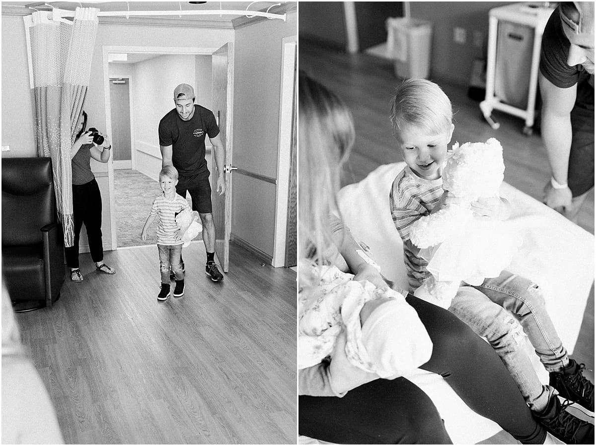 Arielle Peters Photography | Dad and son seeing newborn baby sister for the first time.