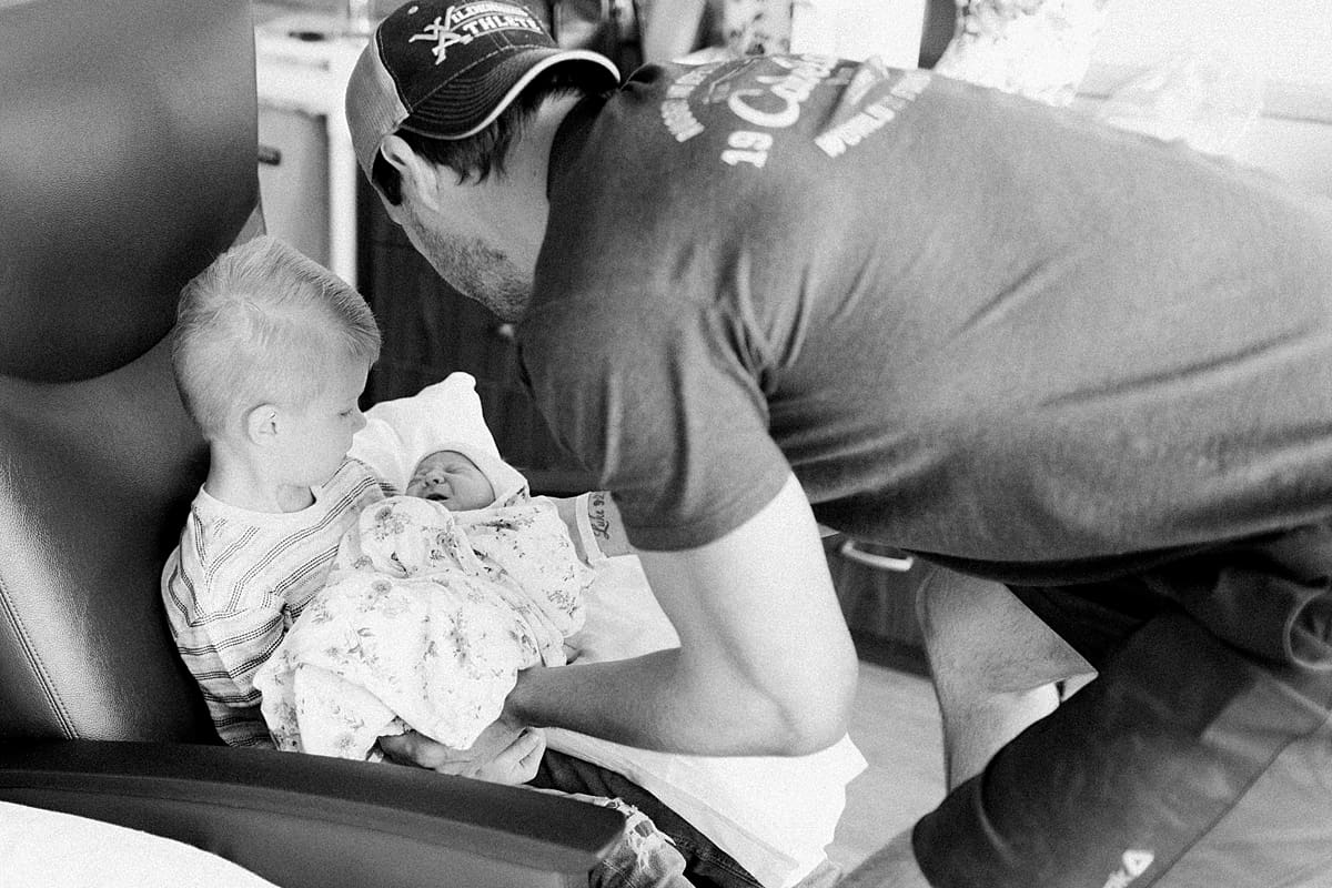  Arielle Peters Photography | Newborn baby girl being held by her big brother. 