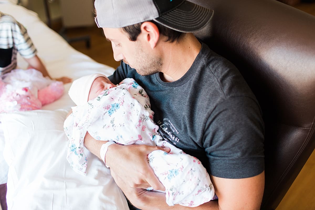 Arielle Peters Photography | Newborn baby girl being held by her dad.