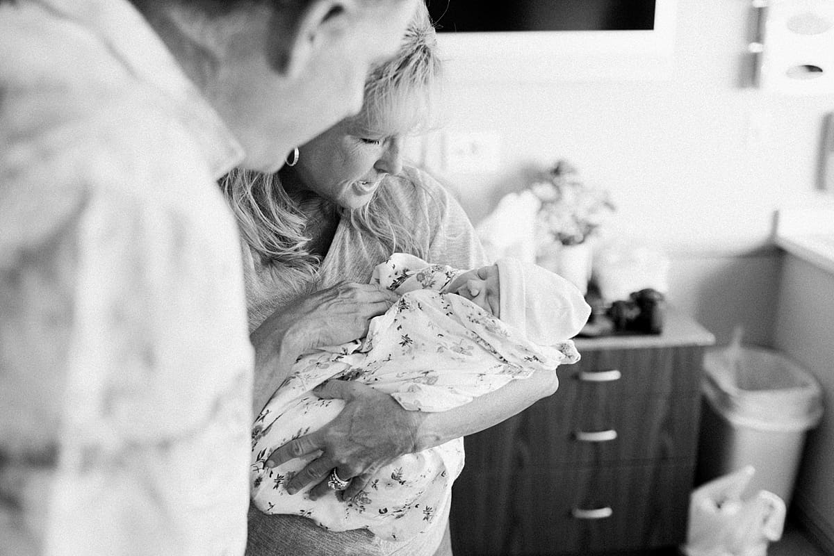 Arielle Peters Photography | Newborn baby girl being held by her grandma.
