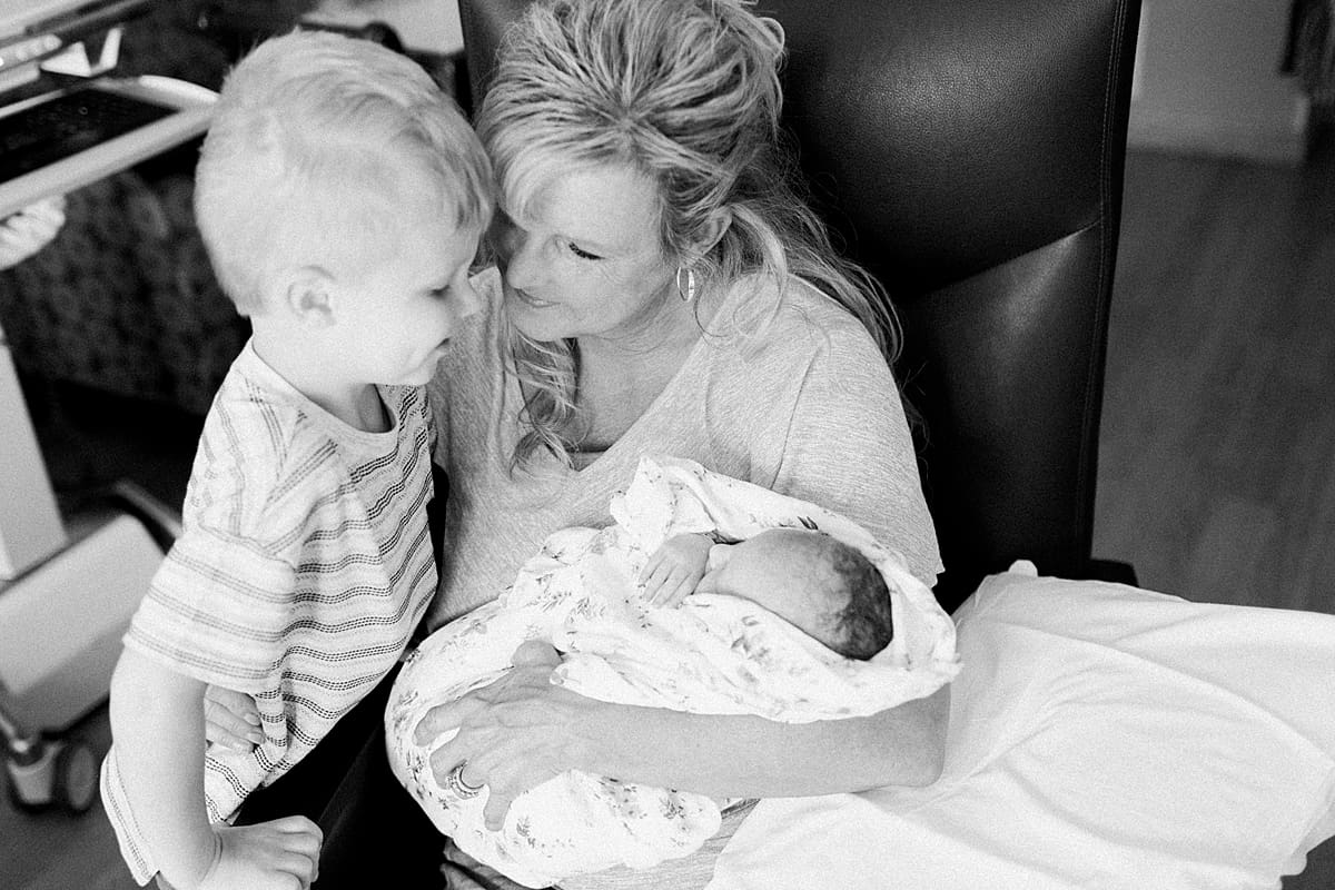 Arielle Peters Photography | Grandma meeting her newborn granddaughter with grandson. 