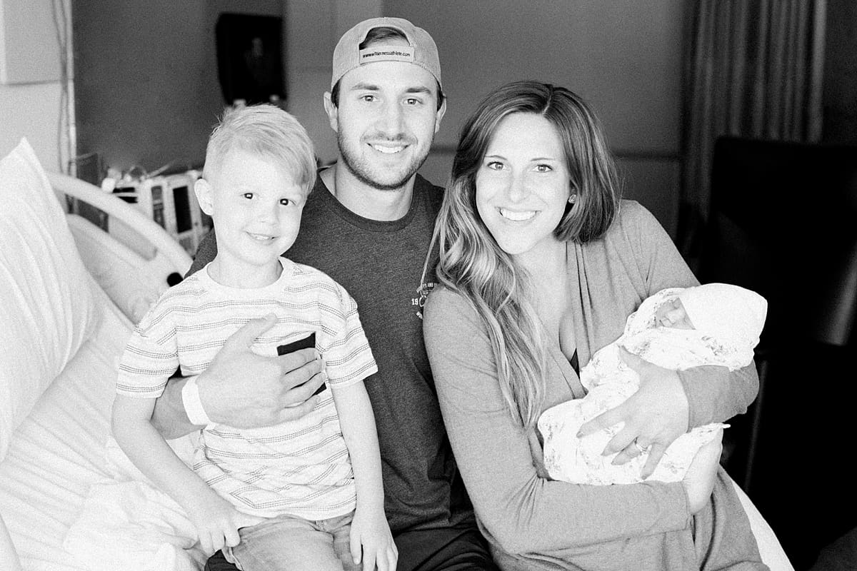 Arielle Peters Photography | Family smiling with their newborn baby girl.