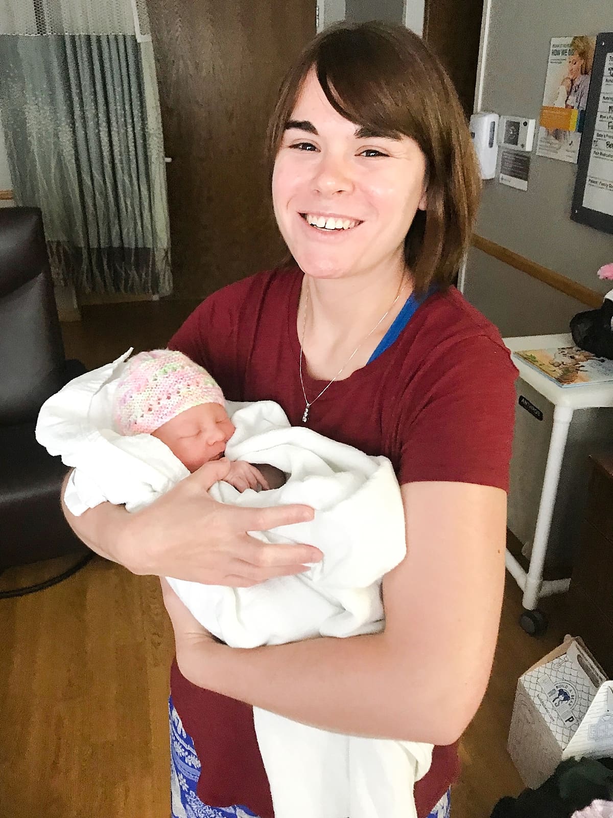 Arielle Peters Photography | Woman holding newborn baby girl.