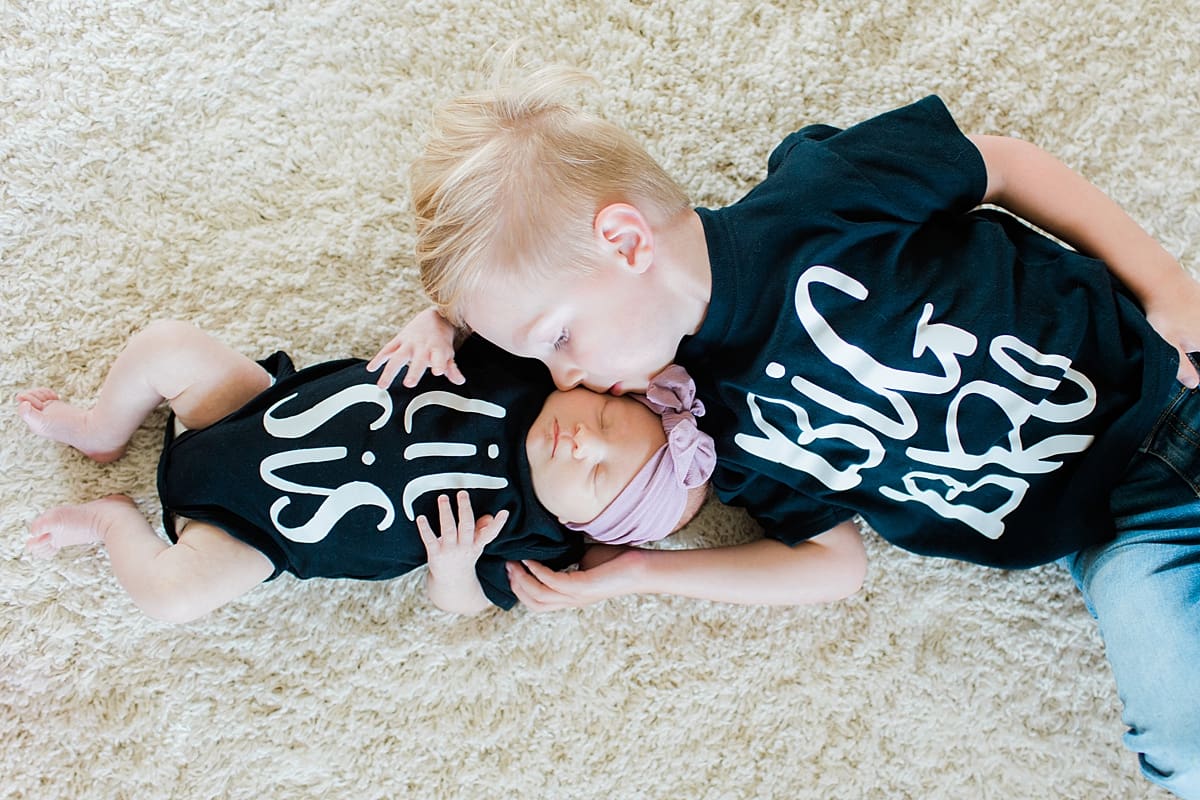 Arielle Peters Photography | Big brother posing with his newborn baby sister in matching t-shirts. 
