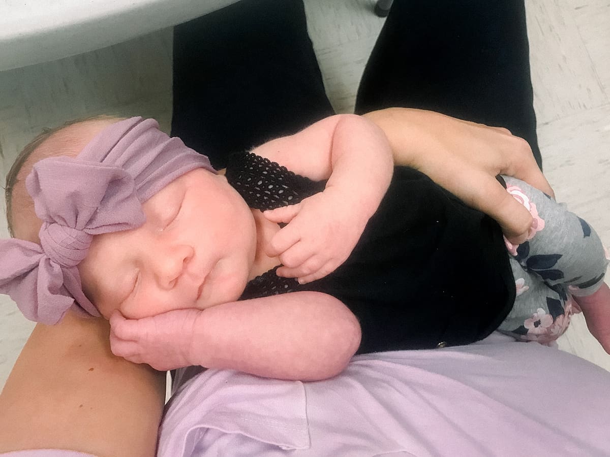Arielle Peters Photography | Newborn baby girl sleeping in her mom's arms. 