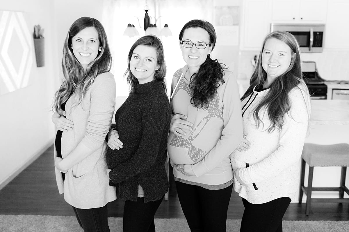Arielle Peters Photography | Four pregnant women holding their bellies and smiling together. 