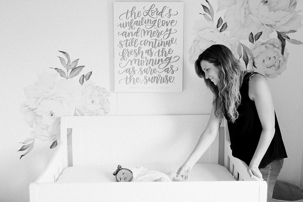 Arielle Peters Photography | Mom watching her newborn baby girl sleeping in her cradle. 