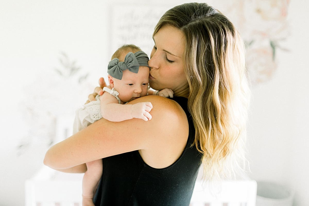 Arielle Peters Photography | Mom holding her sleepy newborn baby girl.