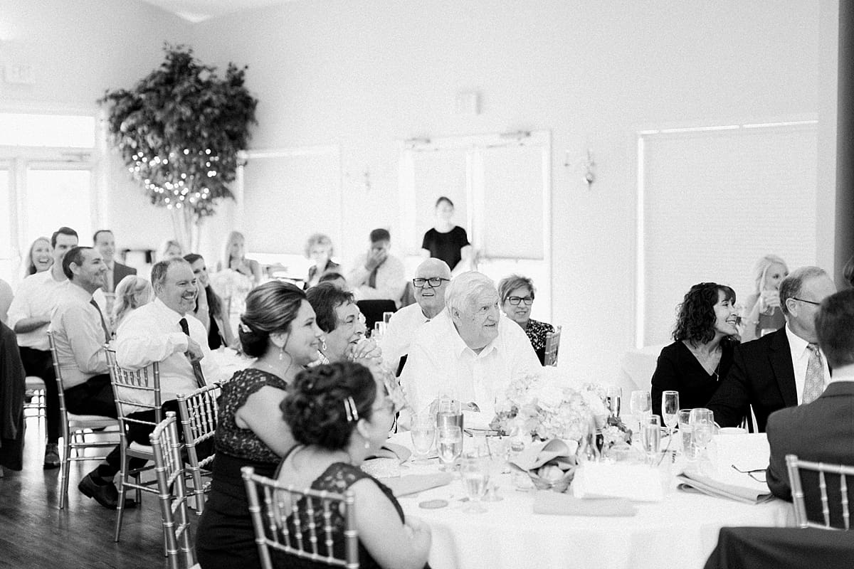 Arielle Peters Photography | Wedding guests laughing at the wedding reception at The Blue Heron at Blackthorn in South Bend, Indiana on wedding day.