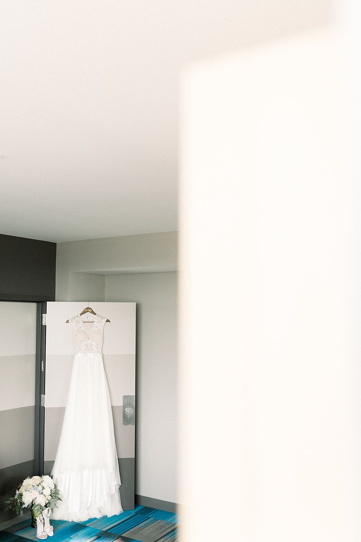 Arielle Peters Photography | Wedding gown hanging at The Blue Heron at Blackthorn in South Bend, Indiana on wedding day.