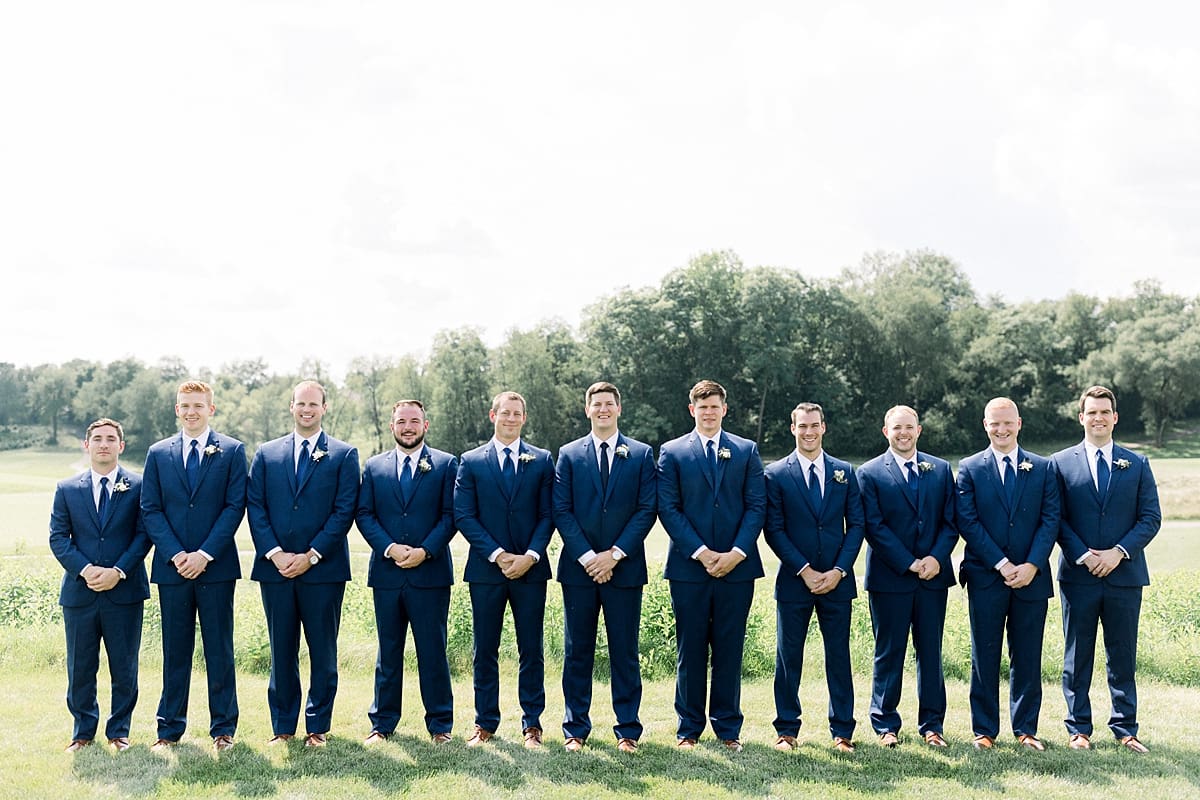Arielle Peters Photography | Groom and groomsmen lined up outside at The Blue Heron at Blackthorn in South Bend, Indiana on wedding day.